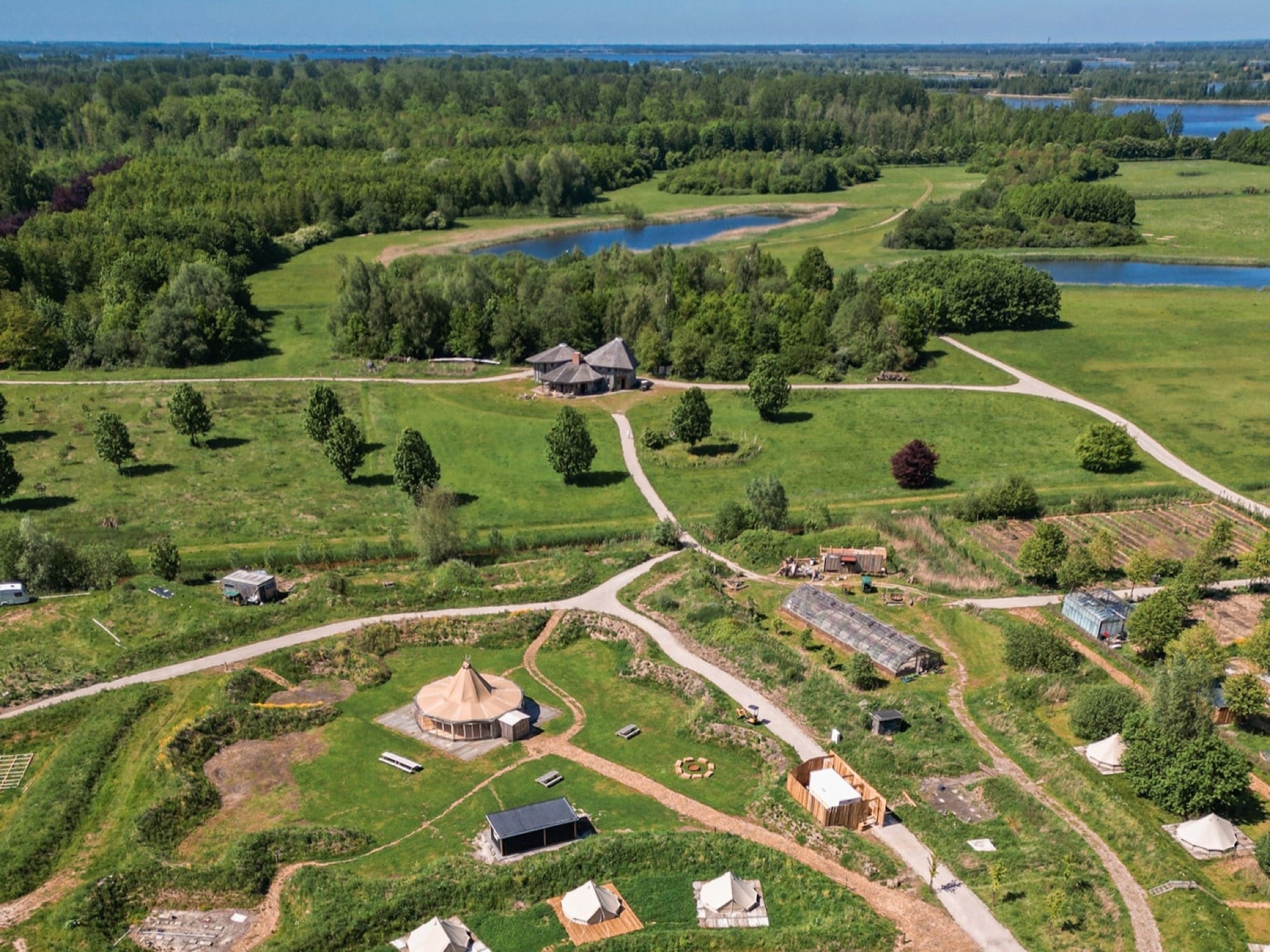 Yūgen Forest from above: meadows, forest, the tipi and the tents