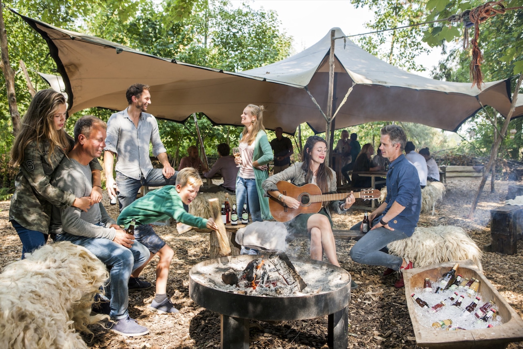 Music and conversation around the fire under the canvas roof